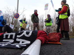 A protestor lies in the road during a blockade of Faslane naval base in 2015